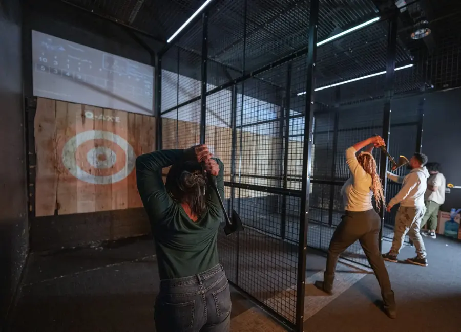Q-ZAR guests enjoy axe throwing in the Carle Place lanes